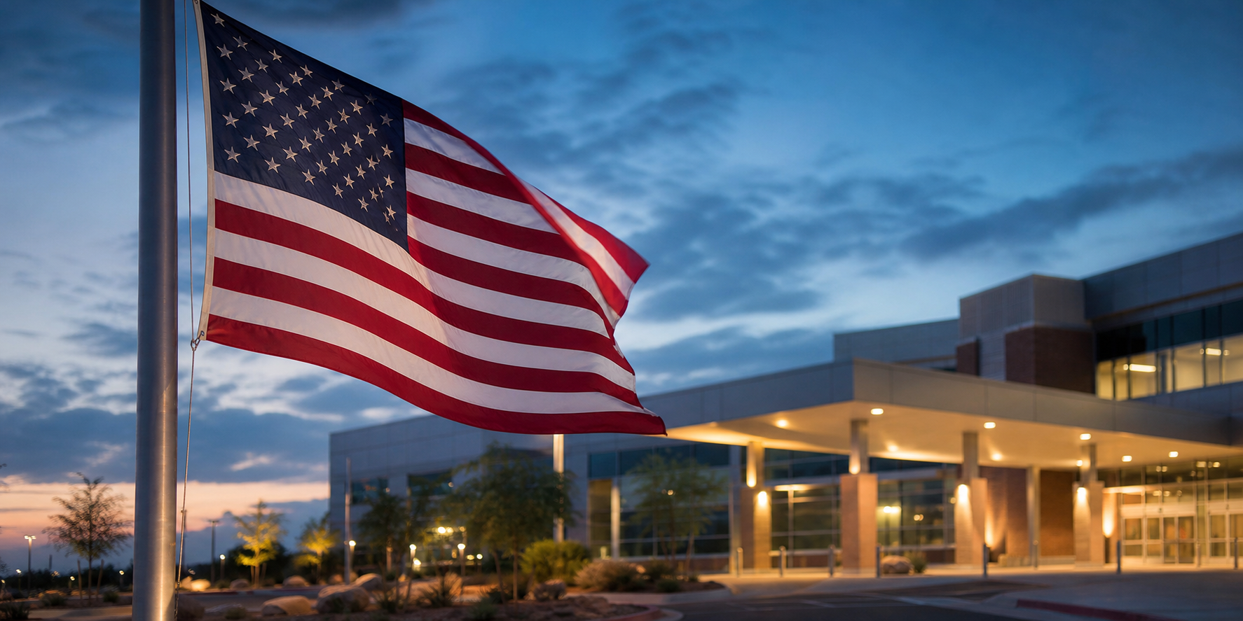 American Flag Outside Modern Hospital At Dusk